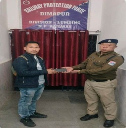 A RPF-NFR official hands over a recovered mobiles phone to rightful owner at Dimapur Railway Station. During the last one year, 528 mobile phones were successfully traced with the help of CEIR portal, informs NFR. (Photo Credit: CPRO NFR)